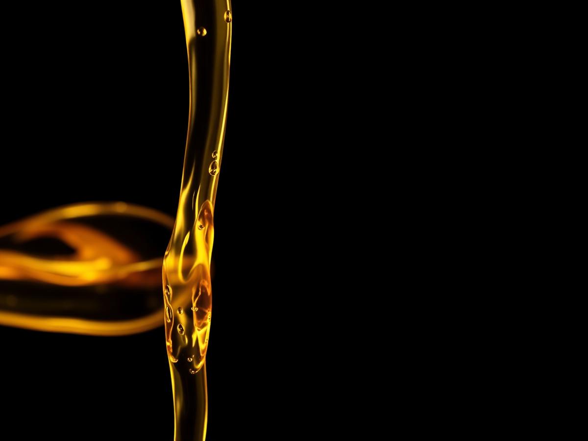 Golden lubricating oil pouring